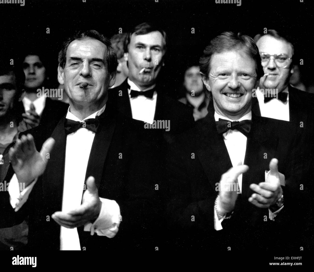 Men at a gentlemens boxing evening wearing black tuxedo and smoking cigars and cigarettes 1990s Stock Photo