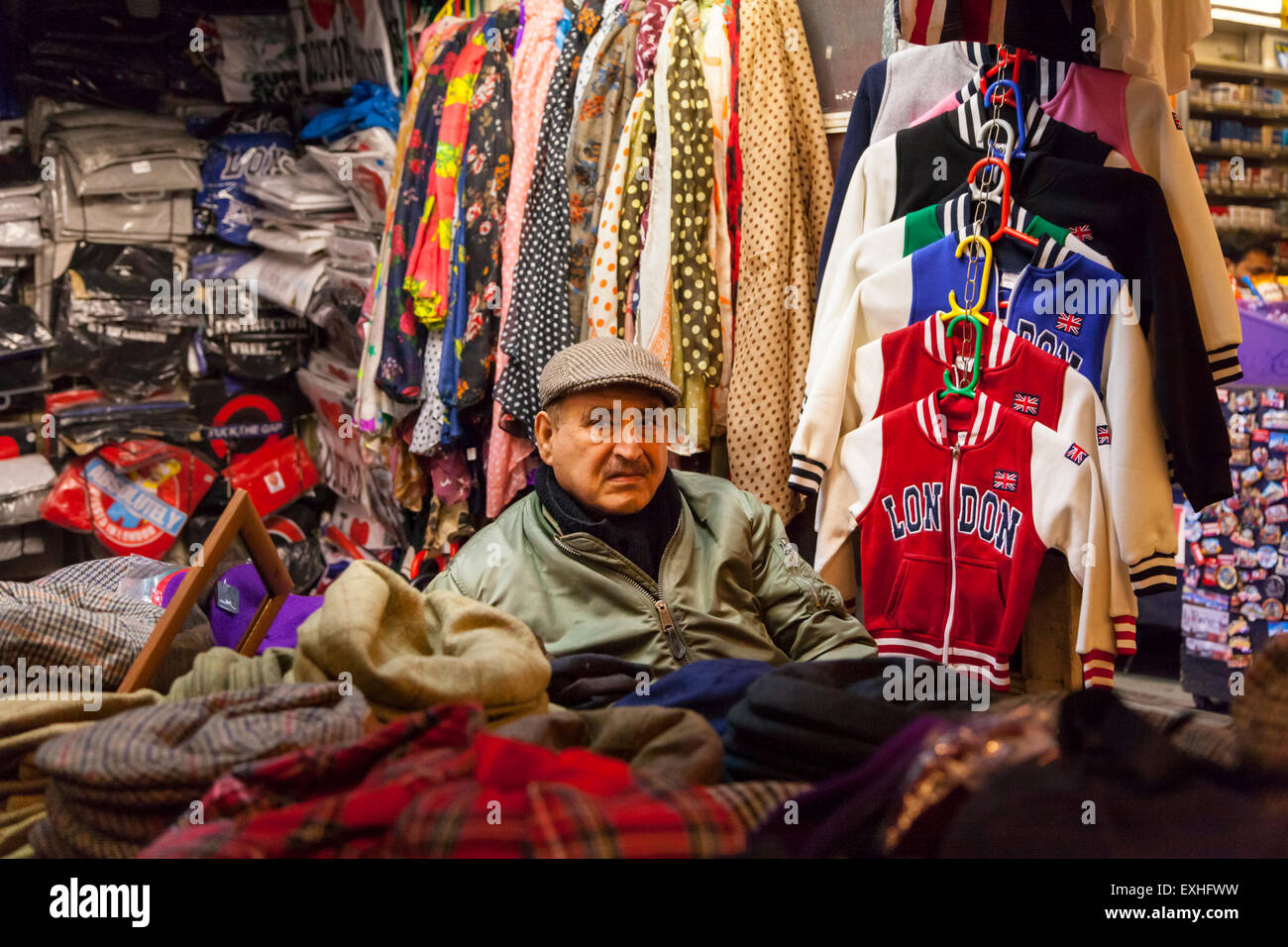 Stall holder in London's Covent Garden, selling souvenirs, hats, scarves and London branded clothing Stock Photo