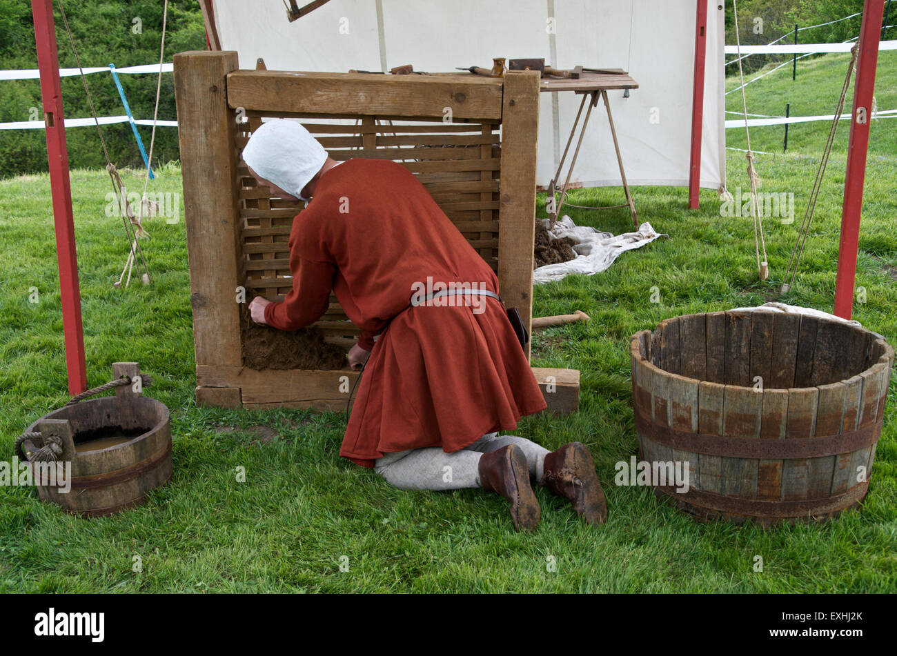 Demonstration of Medieval house building techniques -applying the daub to the wattle Stock Photo