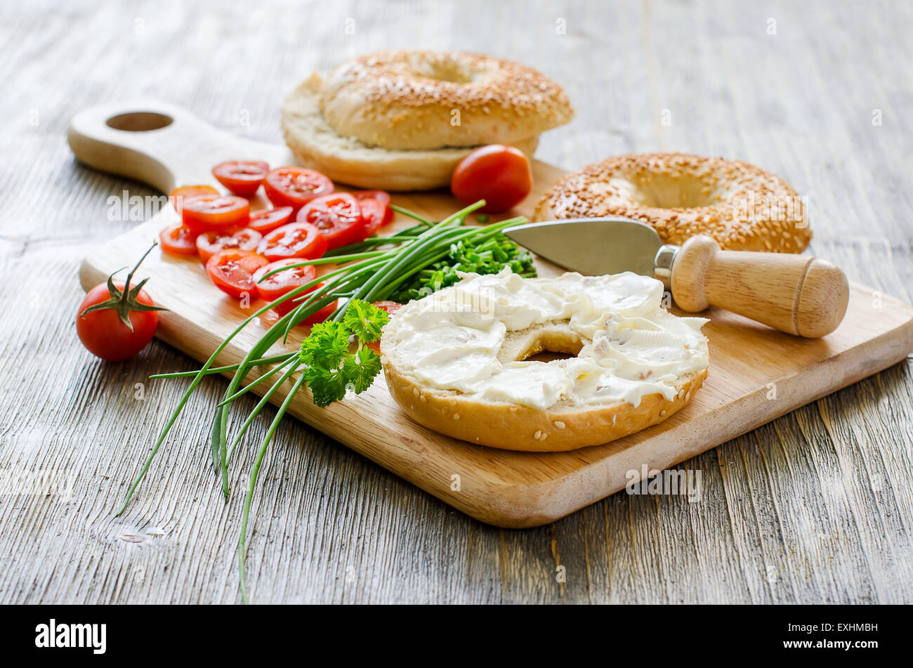 Bagels sandwiches with cream cheese, tomatoes and chives for healthy snack Stock Photo