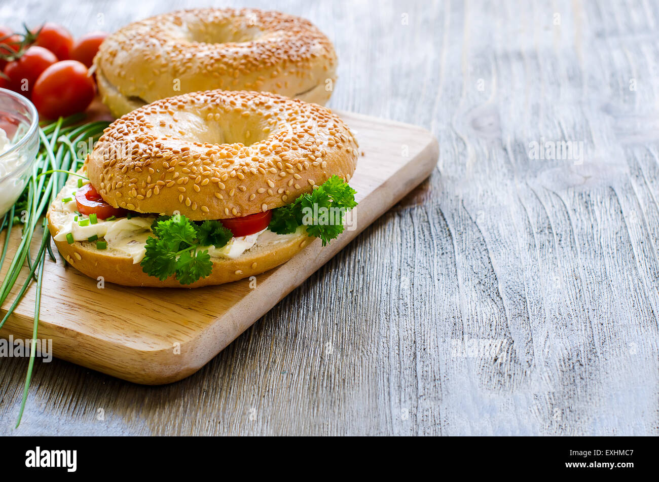 Bagels sandwiches with cream cheese, tomatoes and chives for healthy