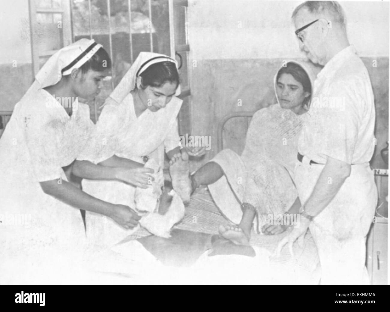 Patient, doctor, and nurses, Satbarwa Hospital, Biahr, India, 1967 1 Stock Photo