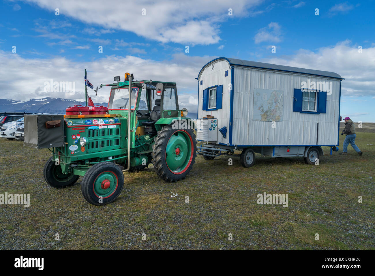 Homemade caravan being pulled by a farm tractor, in the parking lot of the Jokulsarlon Glacial Lagoon, Iceland Stock Photo