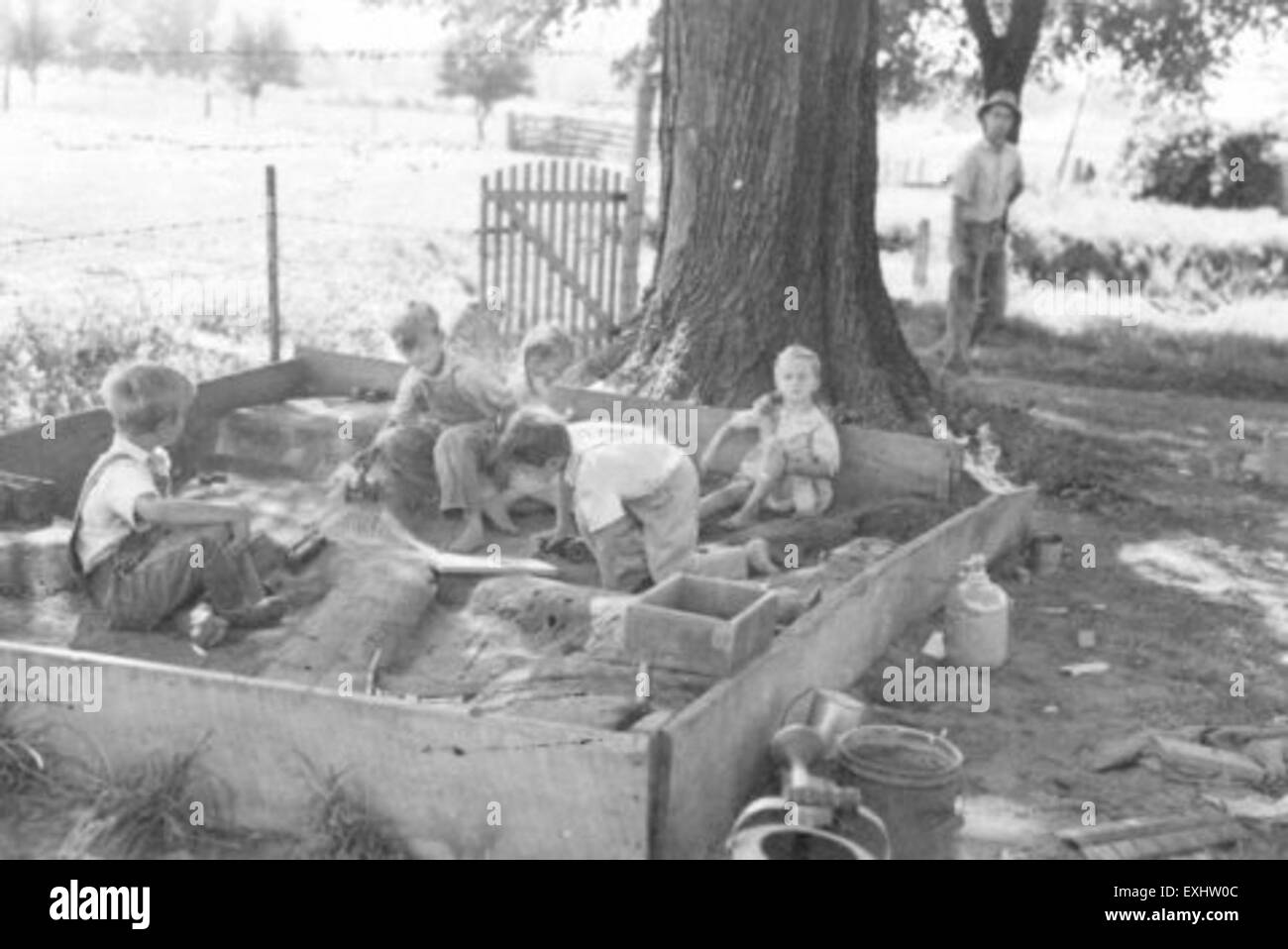 This photograph features children from the Mennonite community in Kidron, Ohio, including members of the Lehman family, playing in a sandbox. The image captures the simple, community-oriented lifestyle of the area. Stock Photo