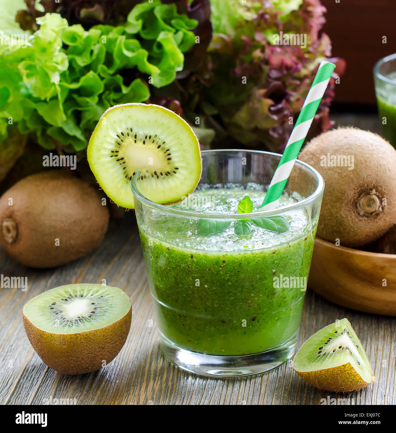 Green healthy kiwi tropical smoothie with ingredients square image Stock Photo