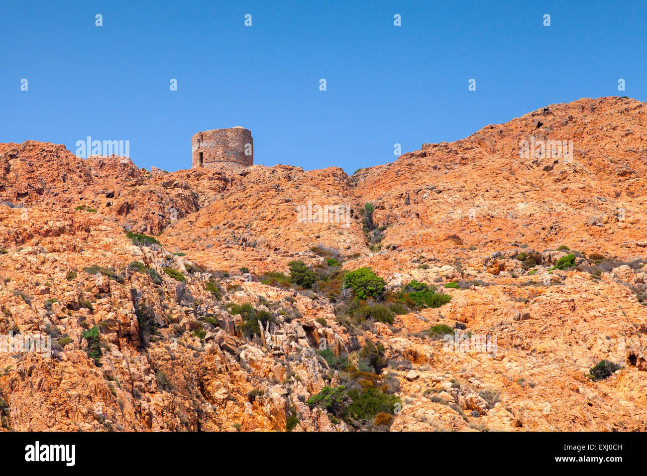 Old Genoese tower on Capo Rosso cliff, Corsica, France. Piana region Stock Photo