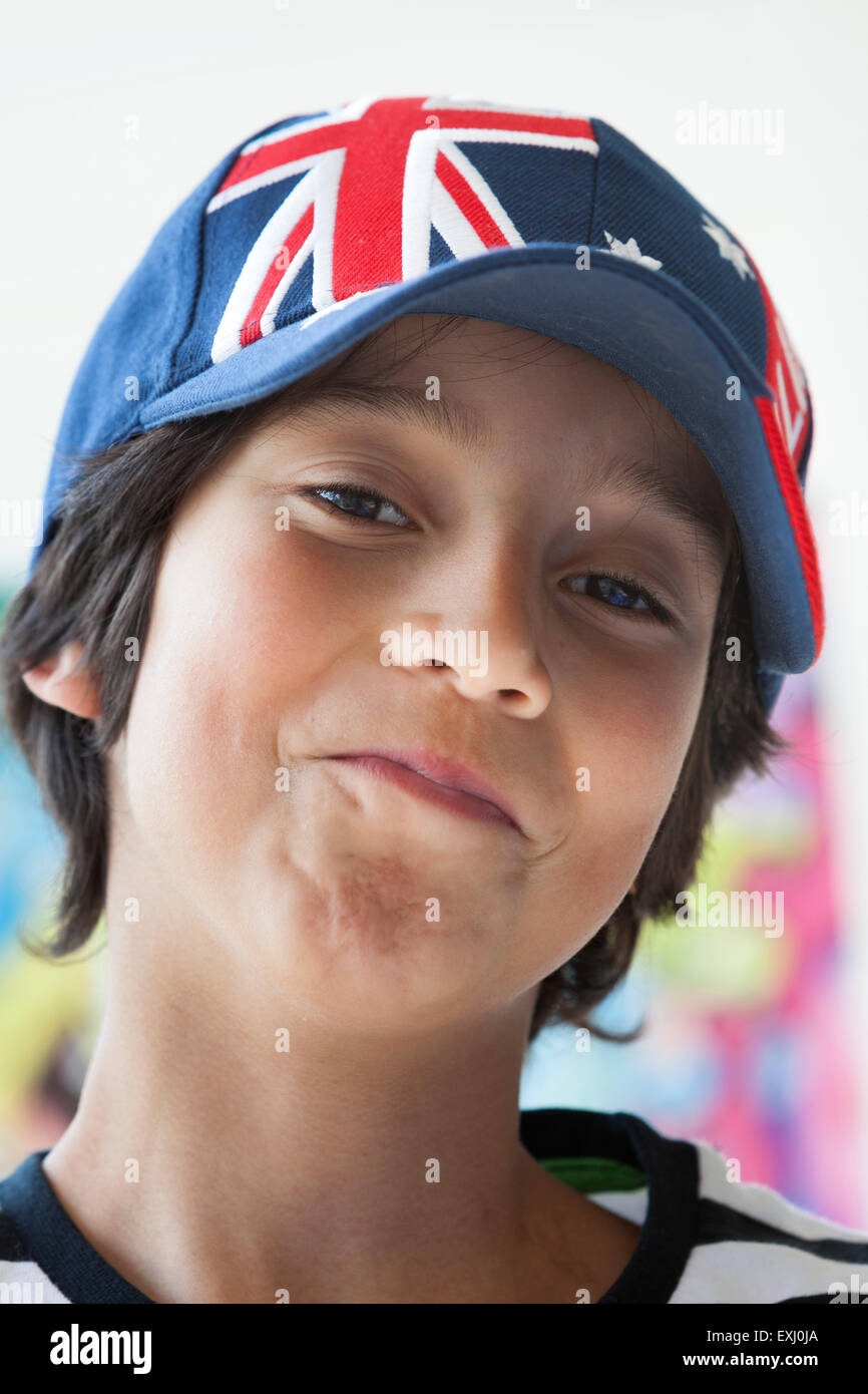 Portrait of a challenging ten year old boy with an australian cap Stock Photo