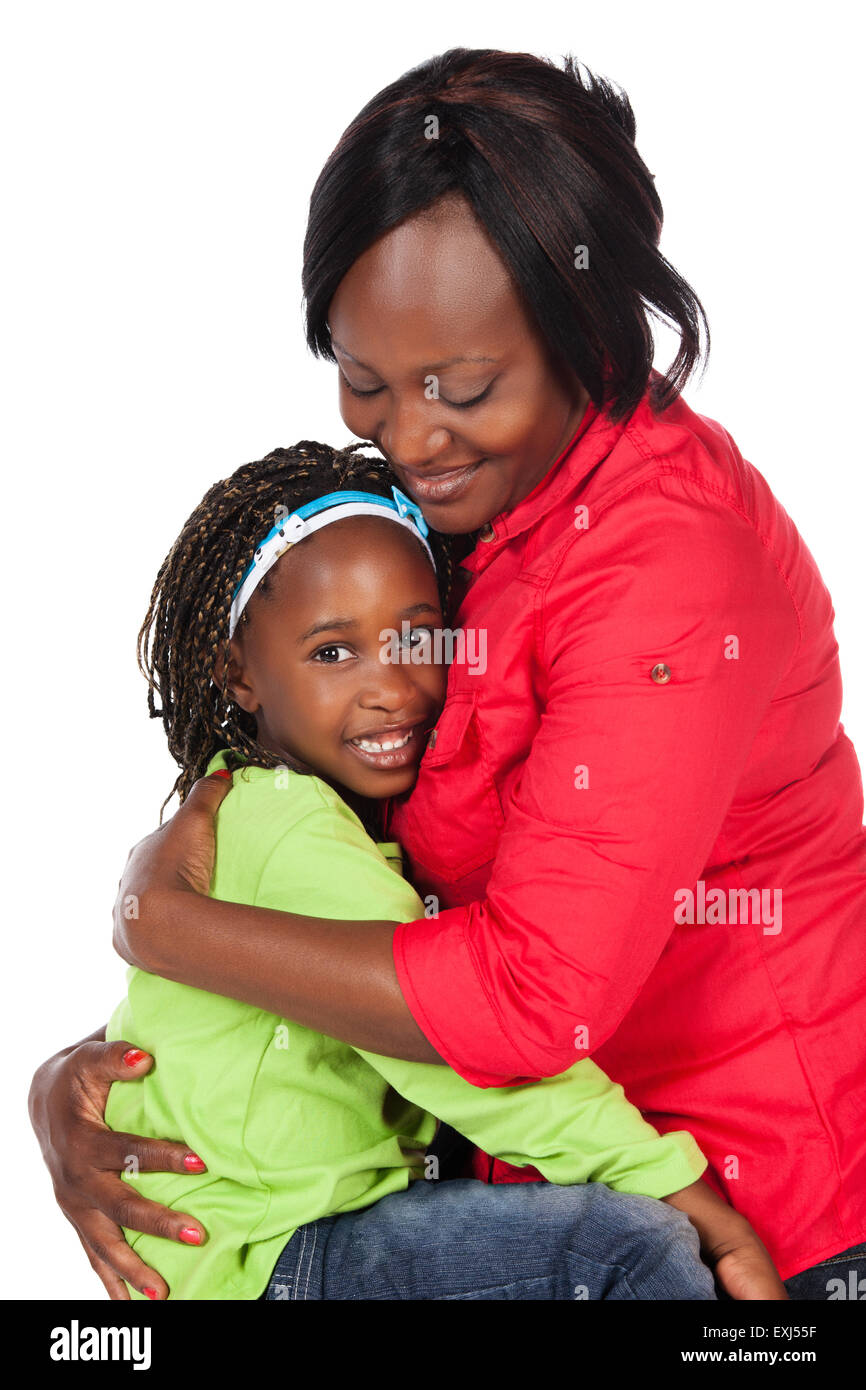 Adorable small african child with braids wearing a bright green shirt and blue jeans and her mother wearing a red shirt. The mom Stock Photo