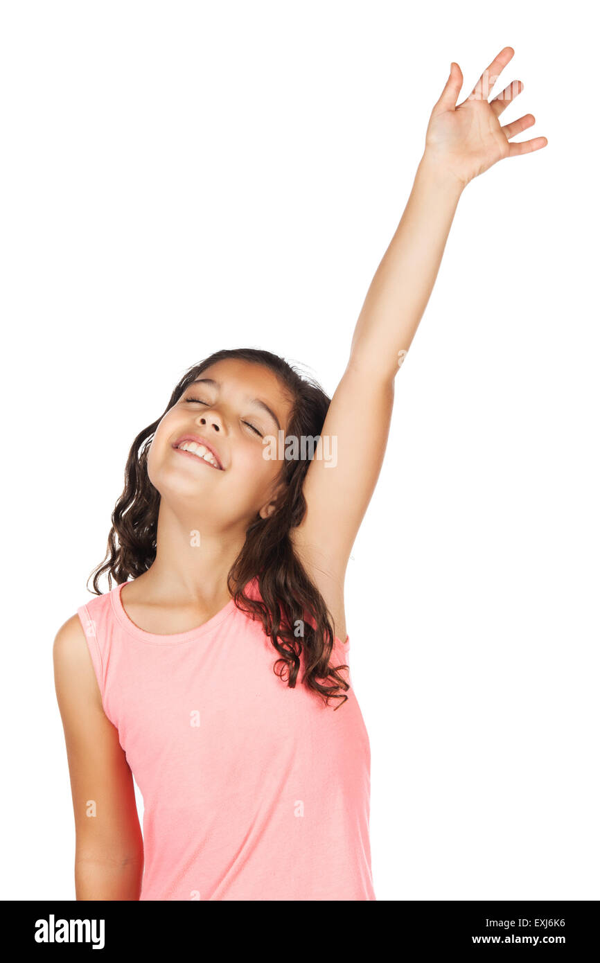 Adorable small african child with braids wearing a bright green shirt. The girl is worshipping with her hand lifted up. Stock Photo
