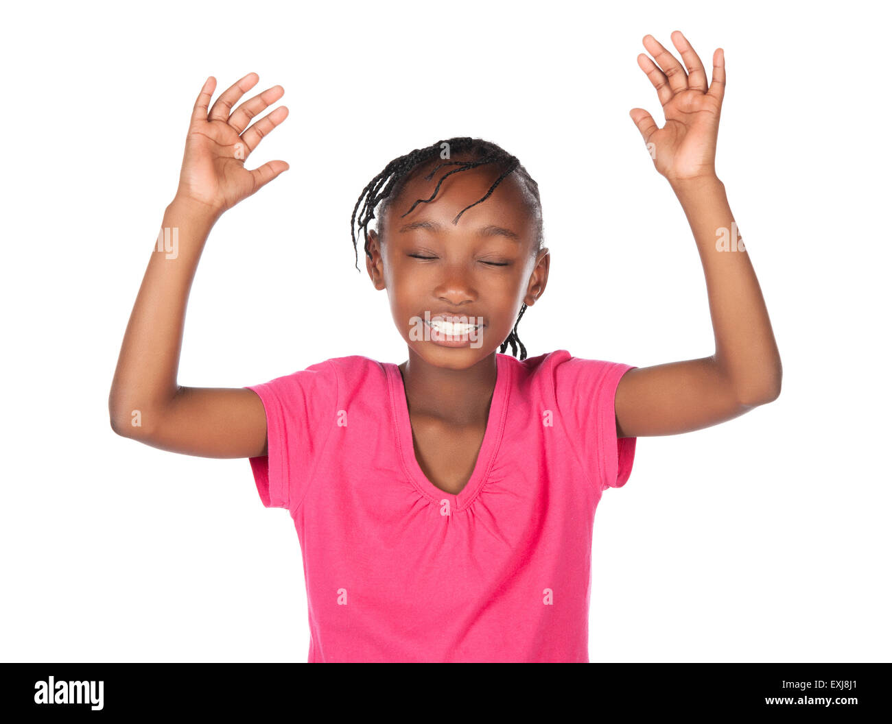 Adorable small african child with braids wearing a bright pink shirt. The girl is worshipping with her hands lifted up. Stock Photo