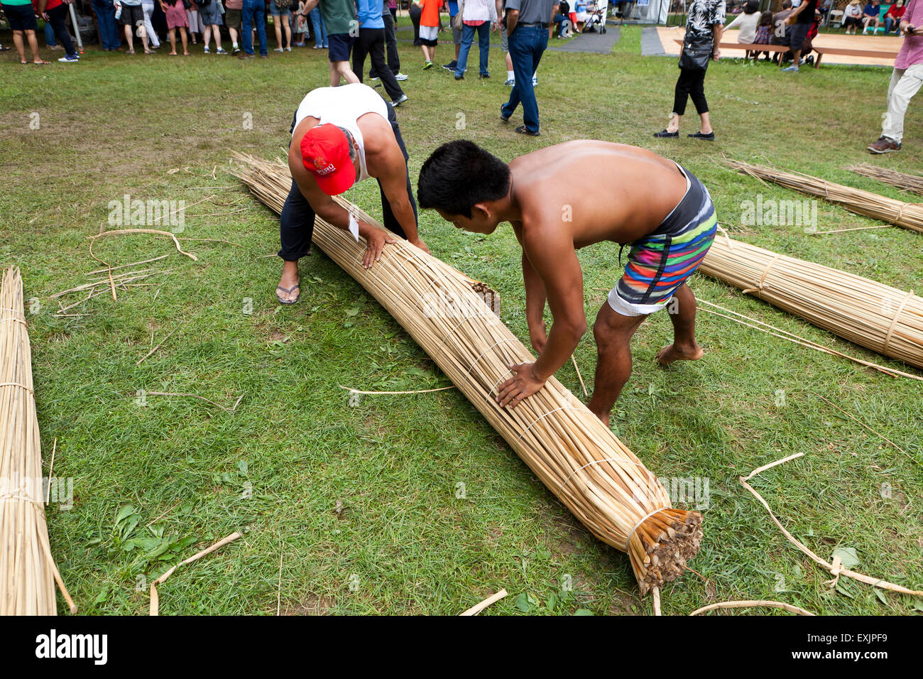 Peruvian men making a totora reed fishing boat Stock Photo