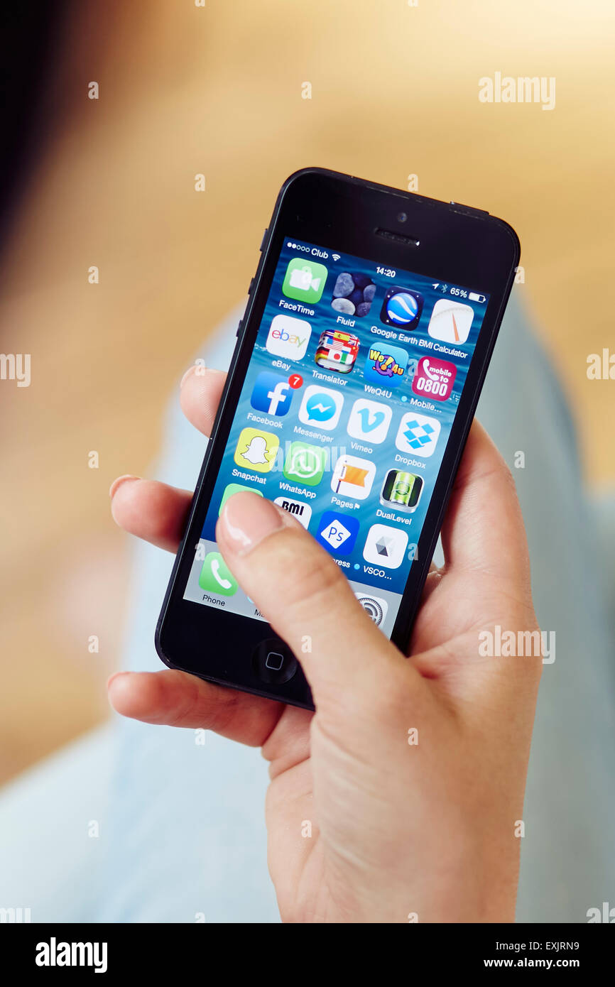 Person browsing through Apps on an iPhone Stock Photo