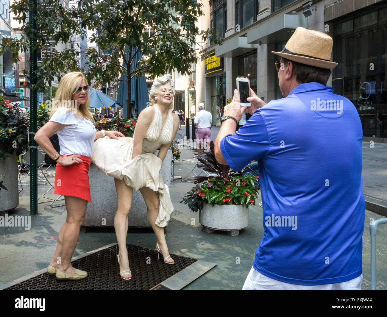Tourists Posing and Taking Photos, Marilyn Monroe Seven Year Itch White Dress updraft Statue, Seward Johnson Exhibit, Broadway Pedestrian Plaza Stock Photo