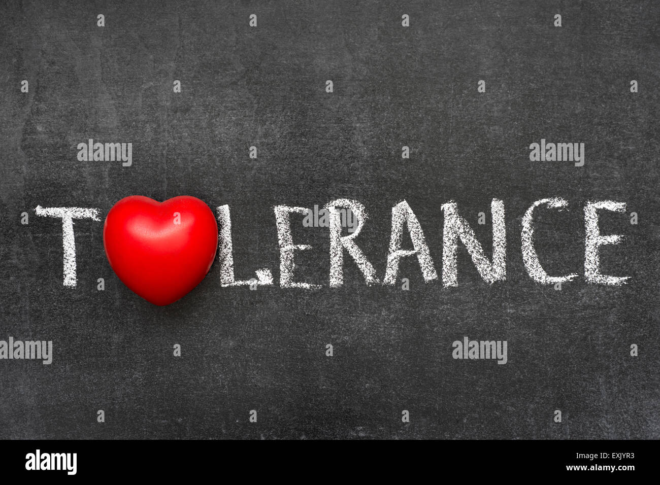 tolerance word handwritten on blackboard with heart symbol instead of O Stock Photo