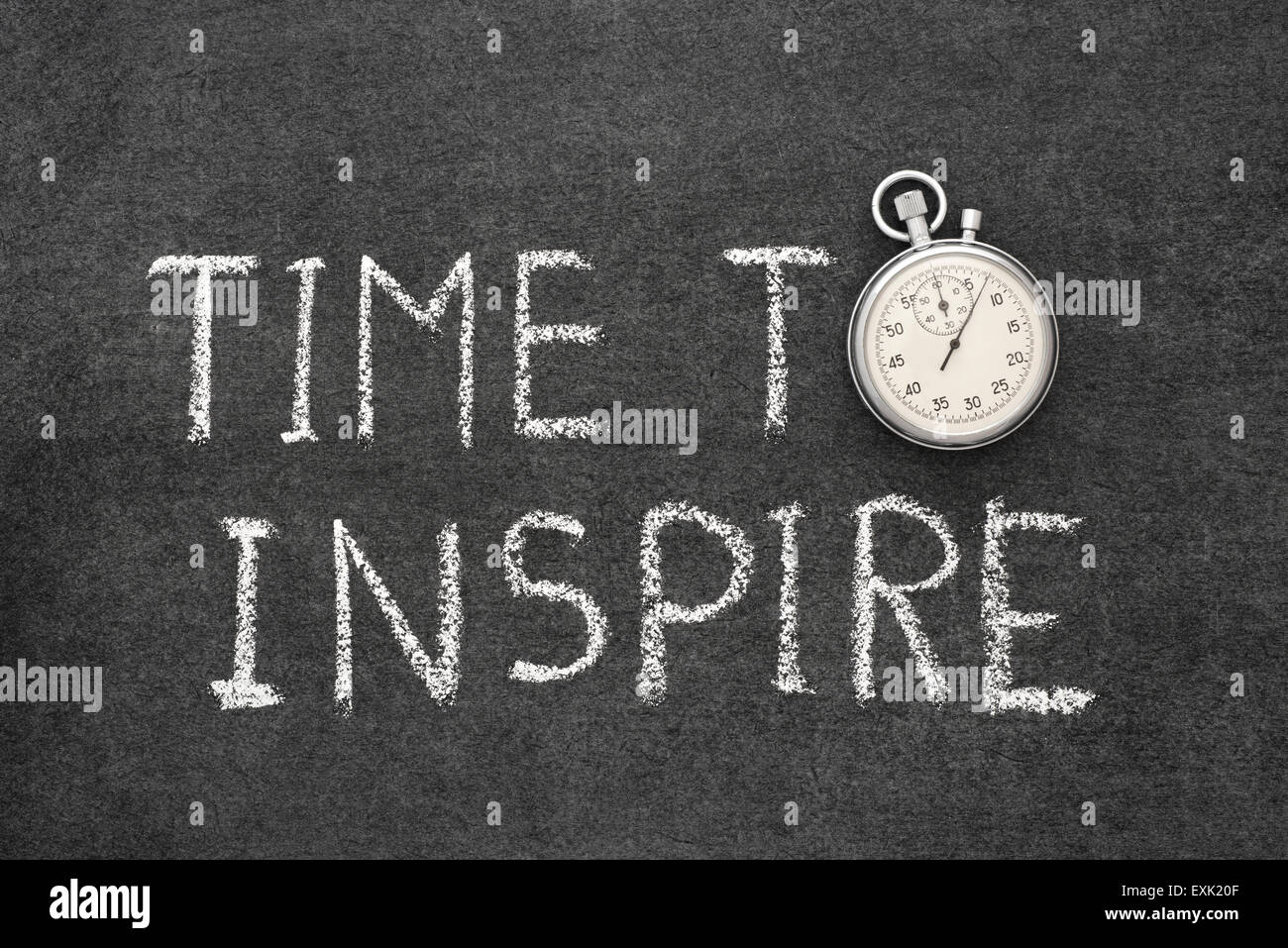 time to inspire concept handwritten on chalkboard with vintage precise stopwatch used instead of O Stock Photo