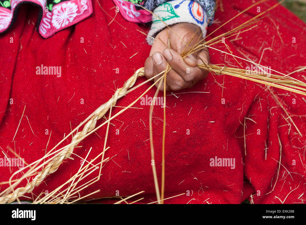 Indigenous Peruvian woman making rope from straw Stock Photo - Alamy