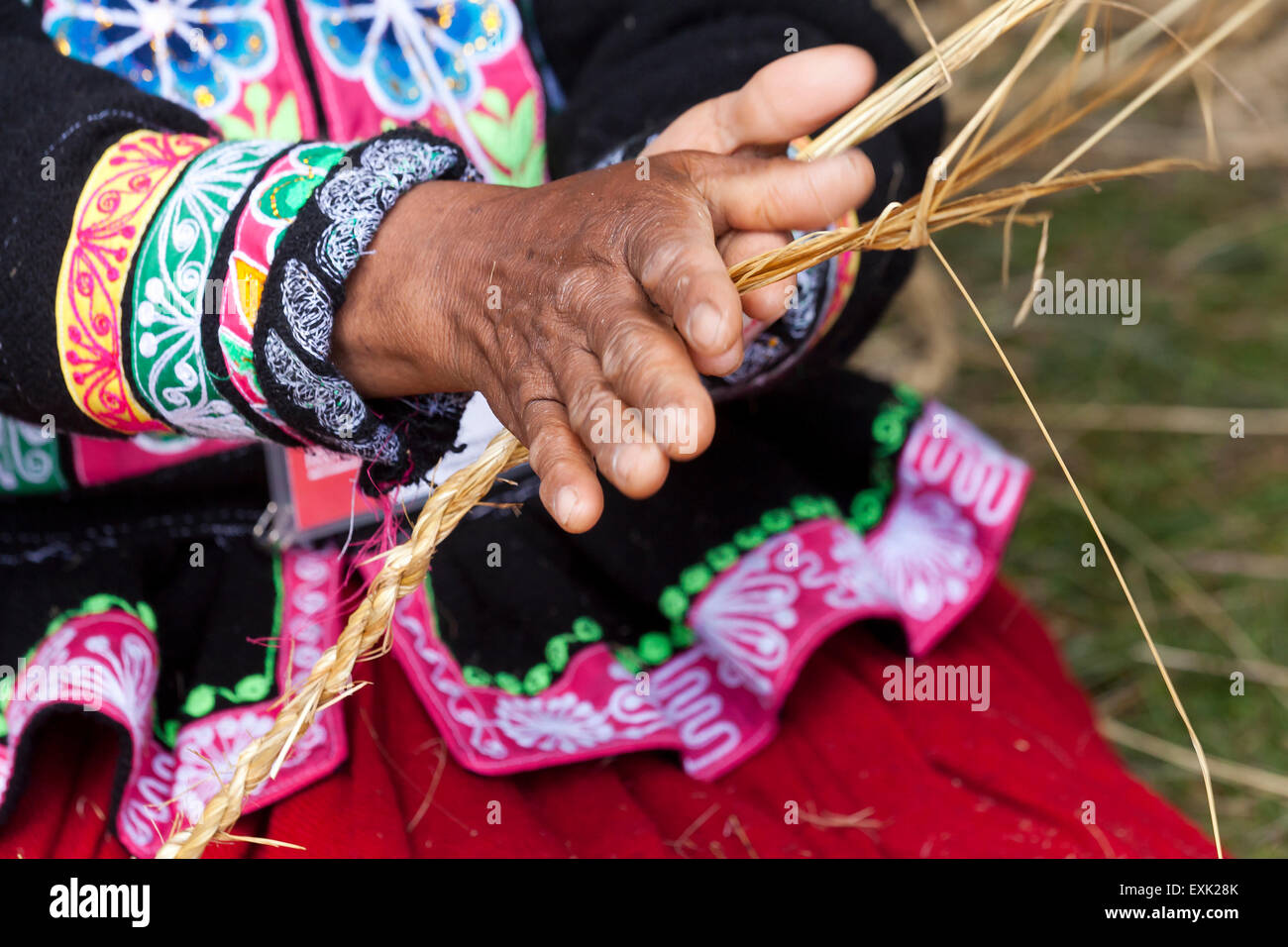 Indigenous Peruvian woman making rope from straw Stock Photo - Alamy