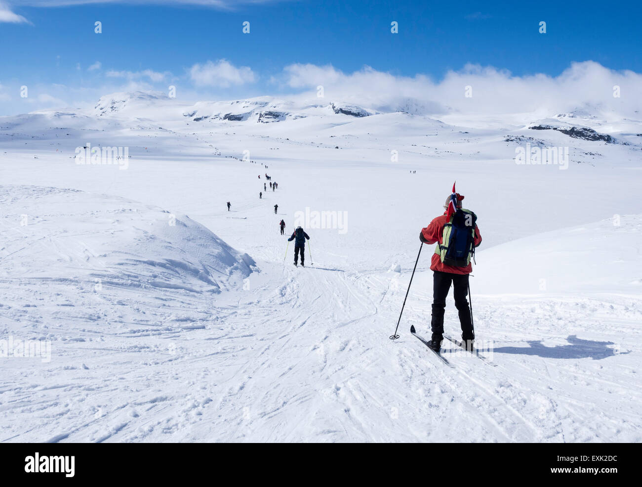 National day 17th May, Norwegians walk on ski , carrying norwegian flags, walk from Finse, highest railway station on railway Os Stock Photo