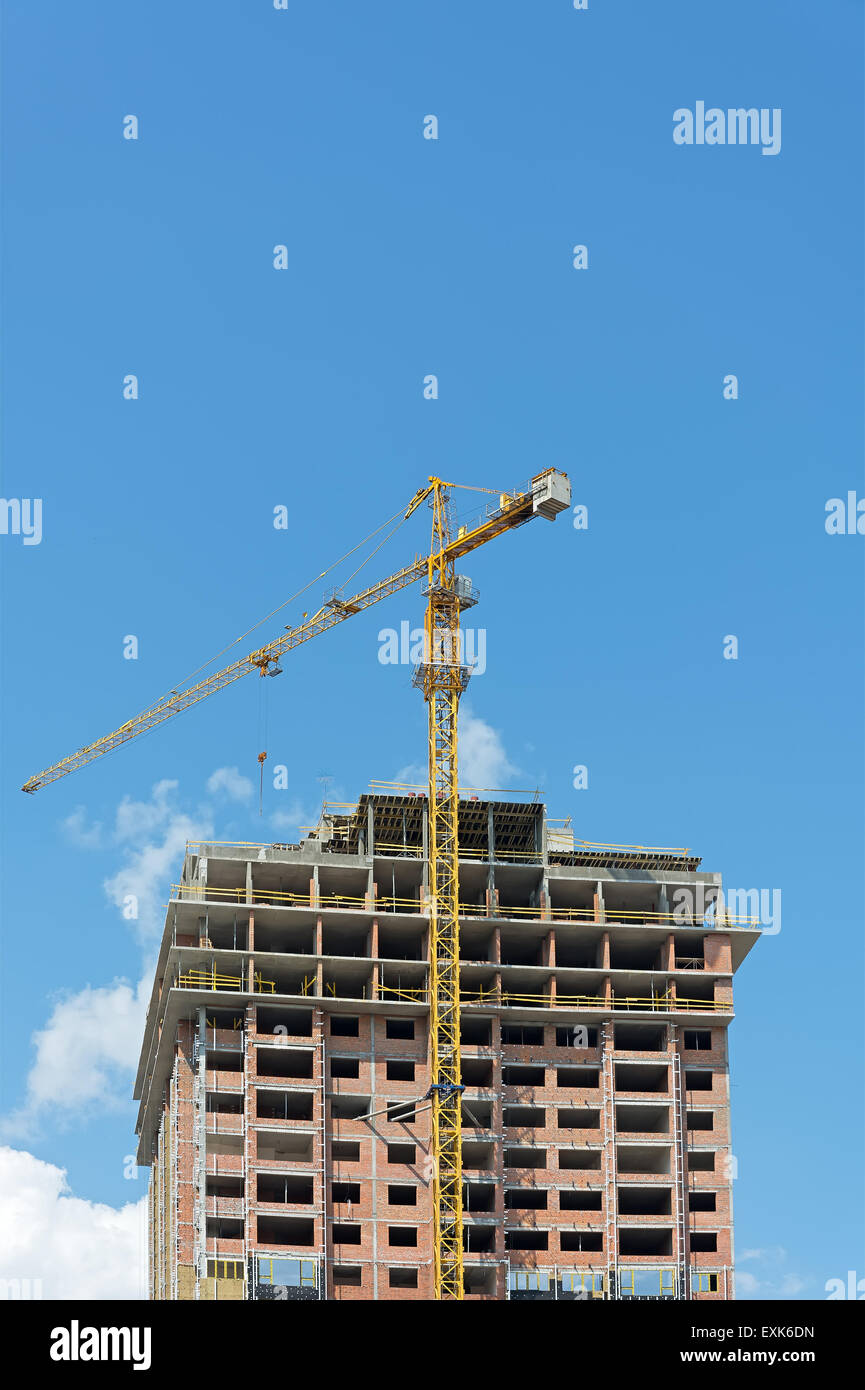 Construction building with crane background with blue sky. Stock Photo