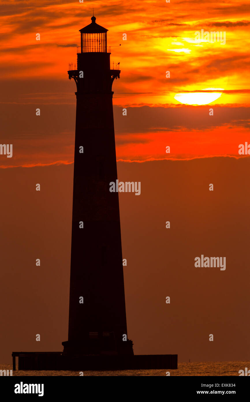 Sunrise over Morris Island Light house seen from Folly Beach July 13