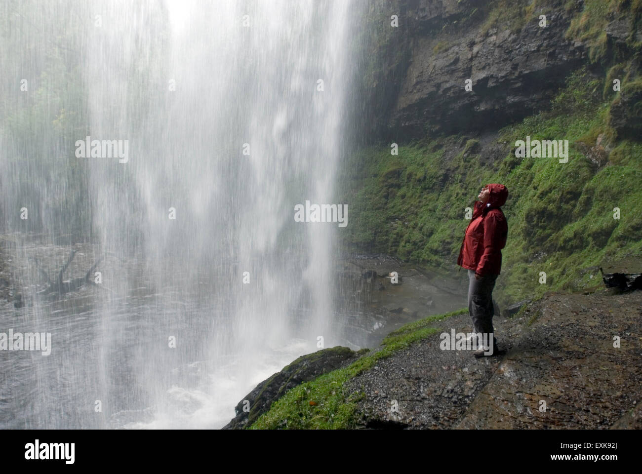Waterfall Henrhyd Falls in Soutwales England Europe with longtime exposure, woman is looking Stock Photo