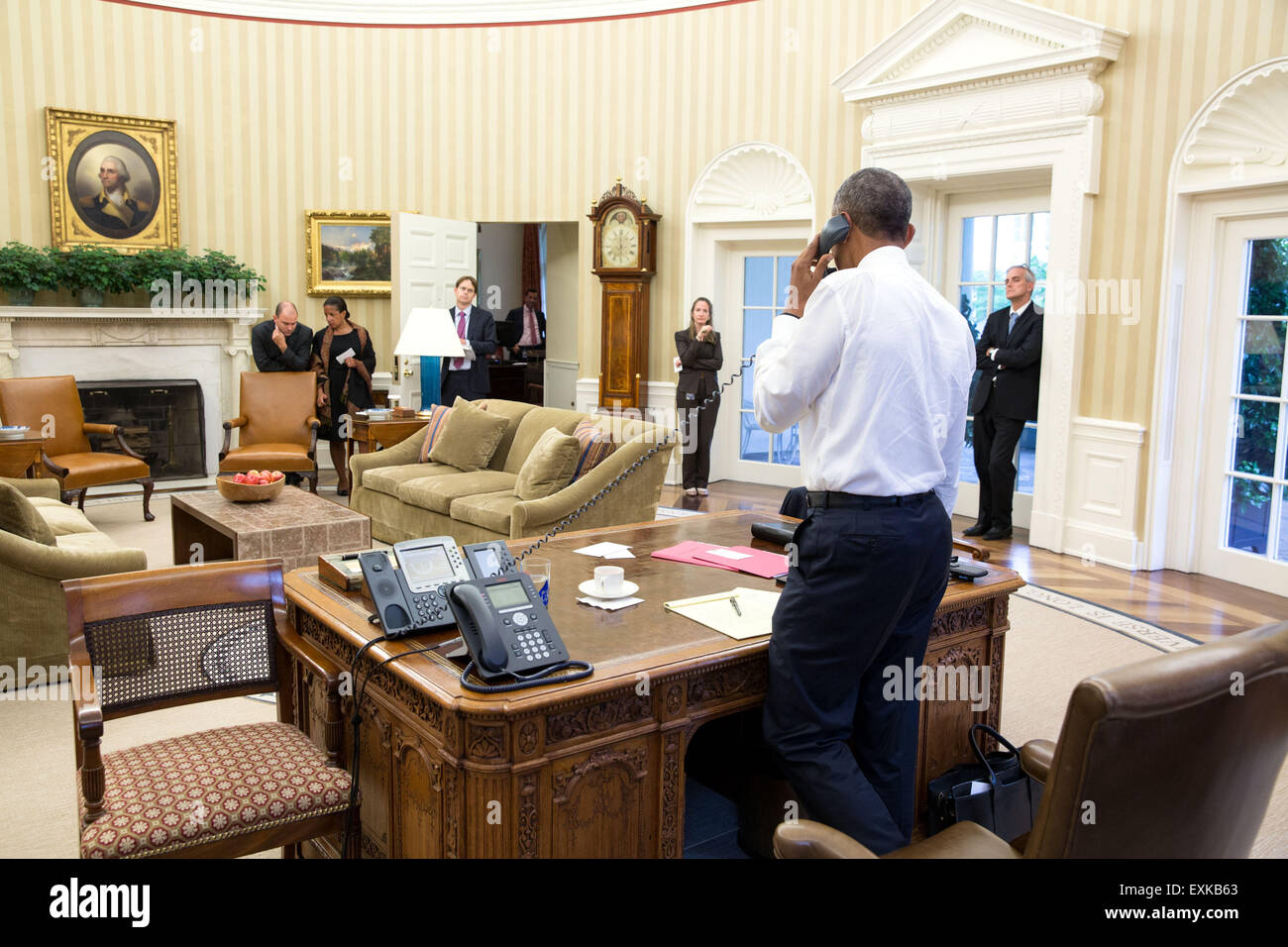 Washington, DC, USA. 14th July, 2015. U.S. President Barack Obama talks on the phone with Secretary of State John Kerry regarding the Iran nuclear agreement in the Oval Office of the White House July 13, 2015 in Washington, DC. Attending from left: Ben Rhodes, Deputy National Security Advisor for Strategic Communications, National Security Advisor Susan E. Rice, Jeffrey Prescott, Senior Director for Iran, Iraq, Syria, and the Gulf States, Avril Haines, Deputy National Security Advisor Counterterrorism and Chief of Staff Denis McDonough. Stock Photo