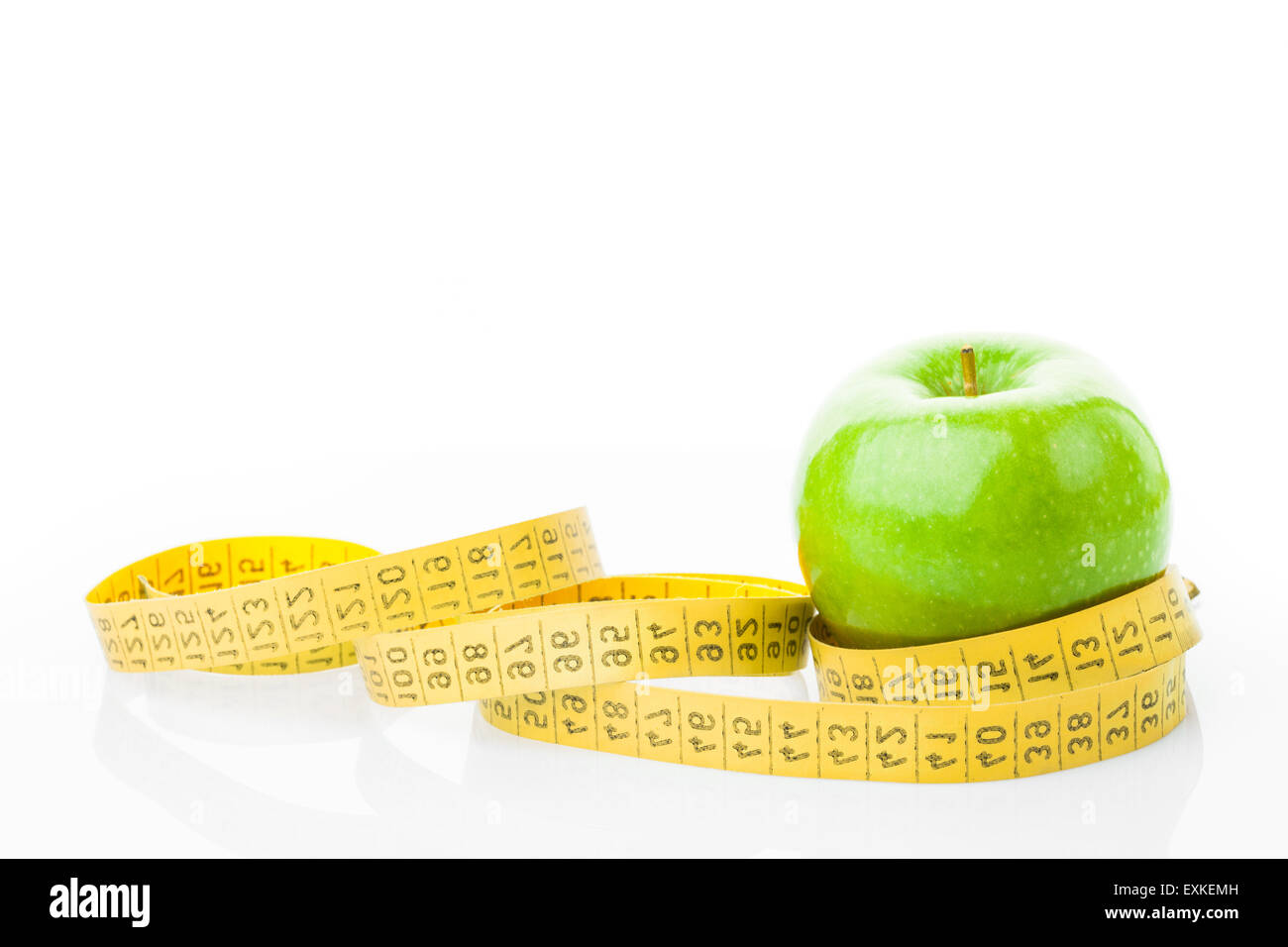 Green apple with measuring tape on white background Stock Photo