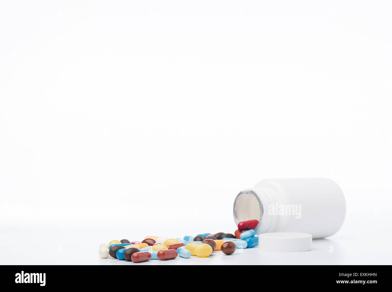 Colorful pills and open bottle of medicine Stock Photo