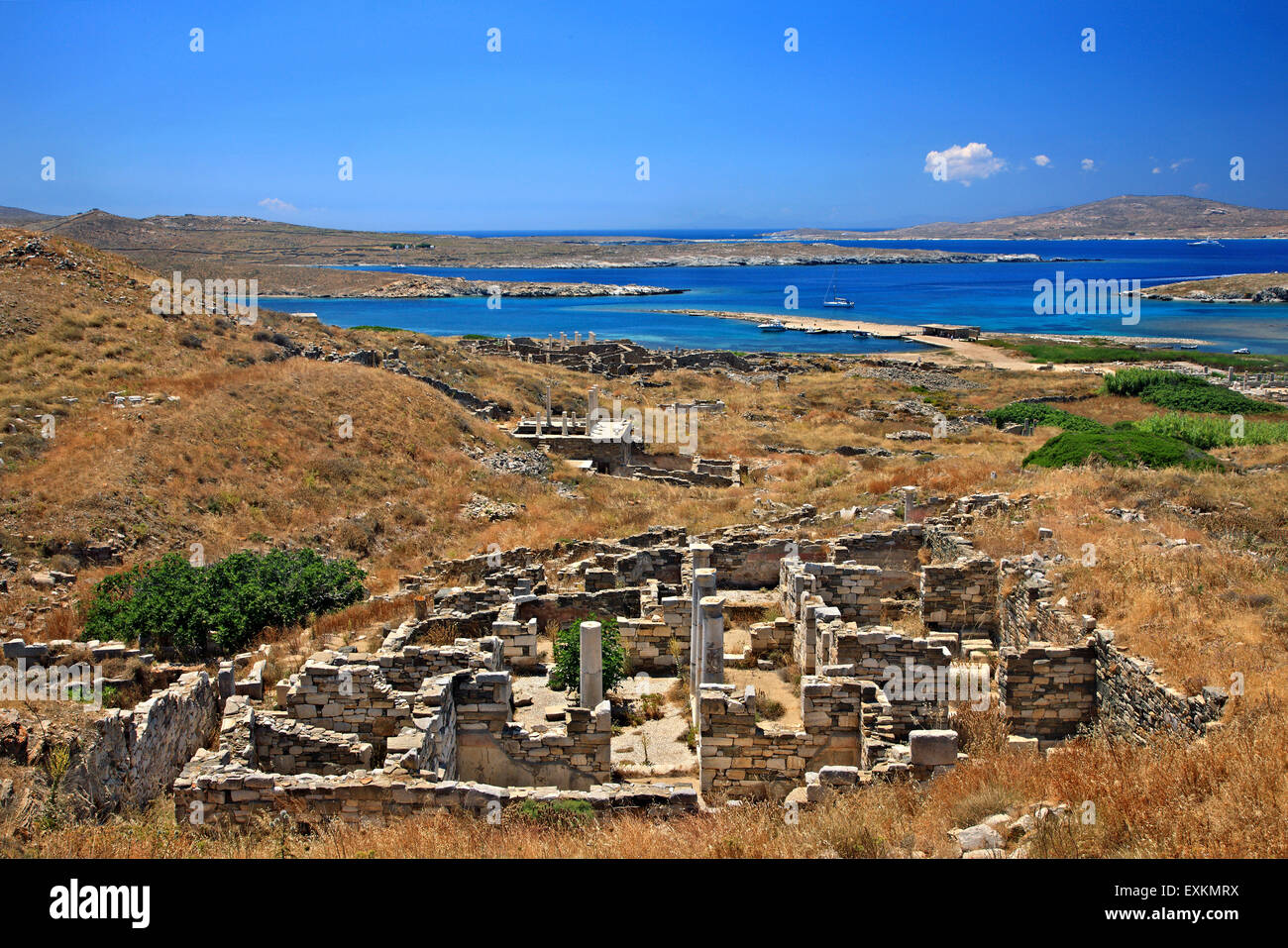 At the archaeological site of the 'sacred' island of Delos. In the background, Rineia island. Cyclades, Greece. Stock Photo