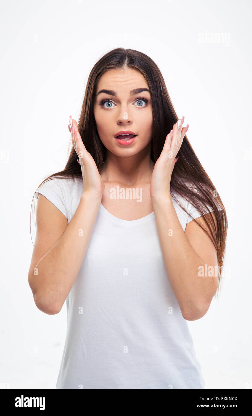 Portrait of surprised young woman standing isolated on a white ...