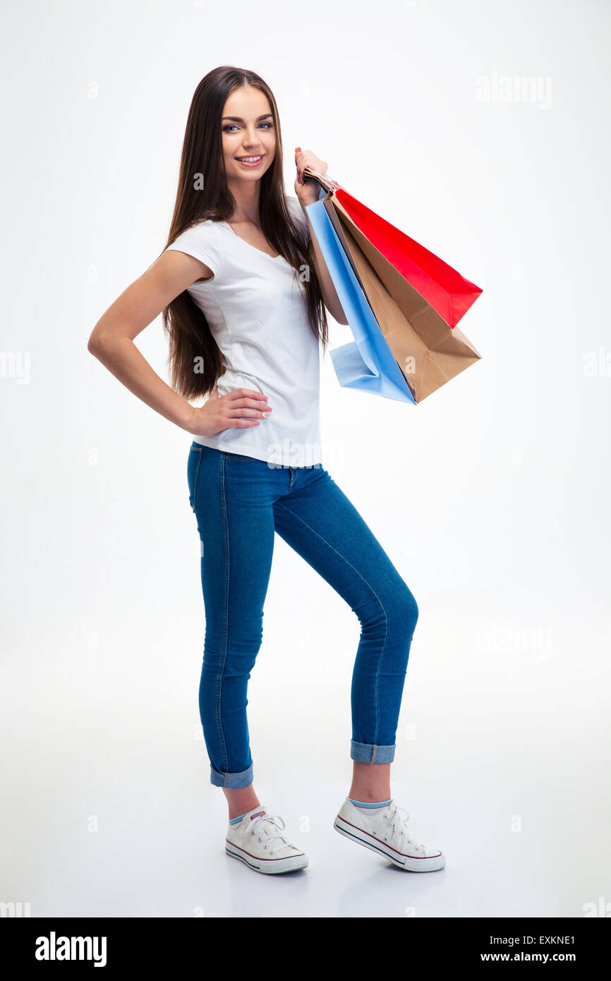 Full length portrait of a smiling attractive woman holding shopping ...