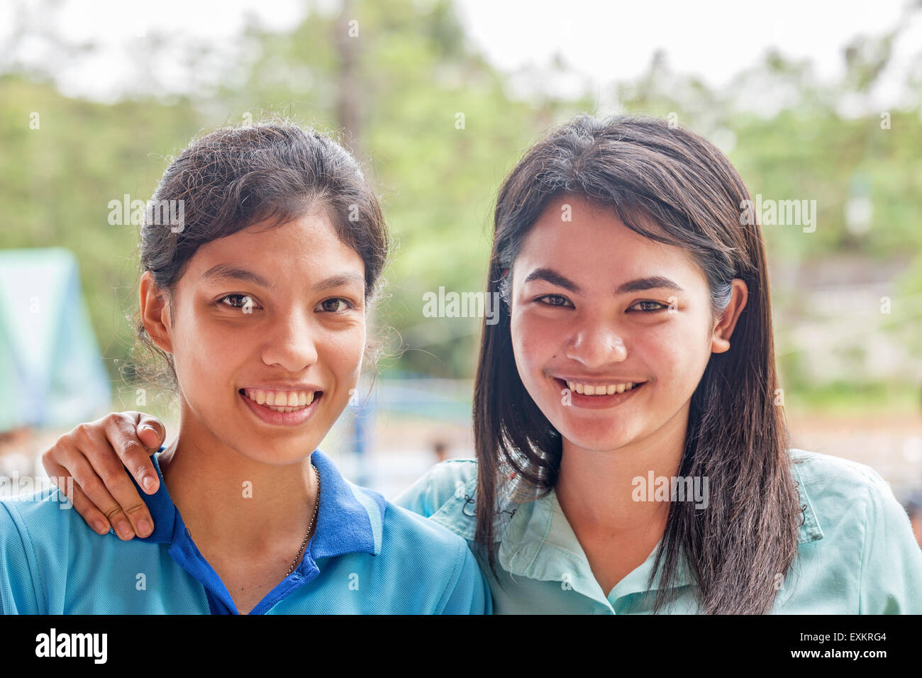 Portrait of two women outdoors hugging and smiling Stock Photo - Alamy