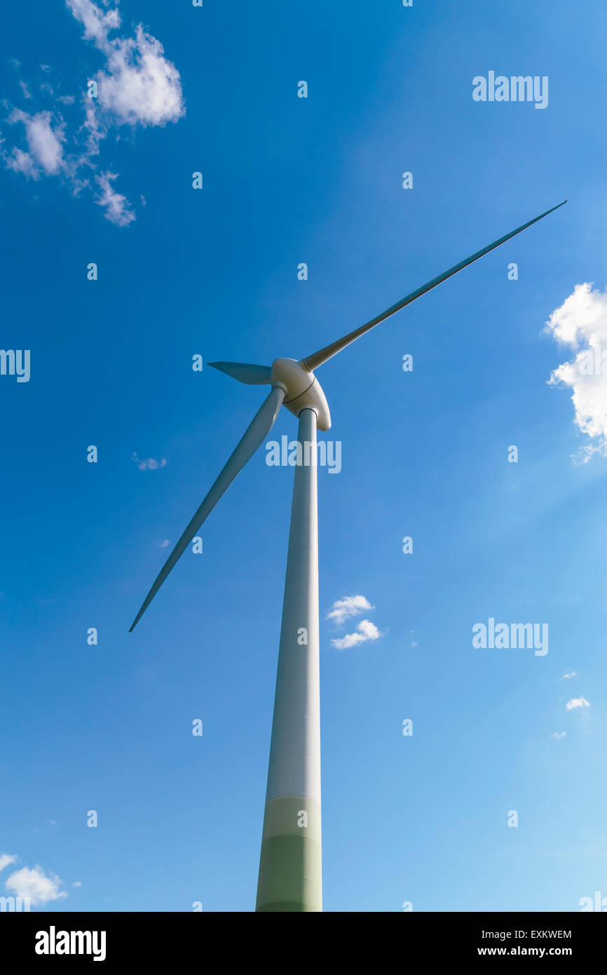 Wind turbine against blue sky with a few clouds Stock Photo - Alamy