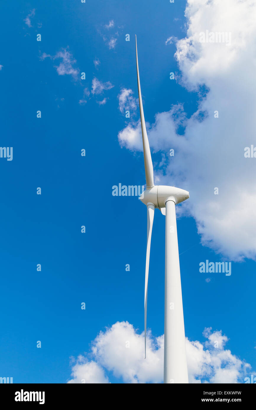 Wind turbine against blue sky with a few clouds Stock Photo - Alamy