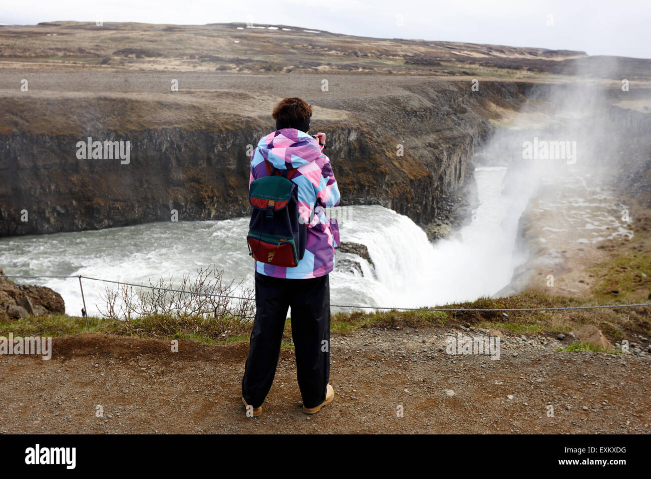 lone female tourist at Gullfoss waterfall Iceland Stock Photo