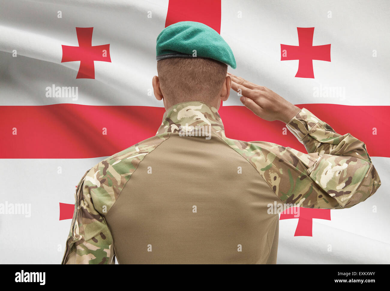 Dark-skinned soldier in hat facing national flag series - Georgia Stock ...