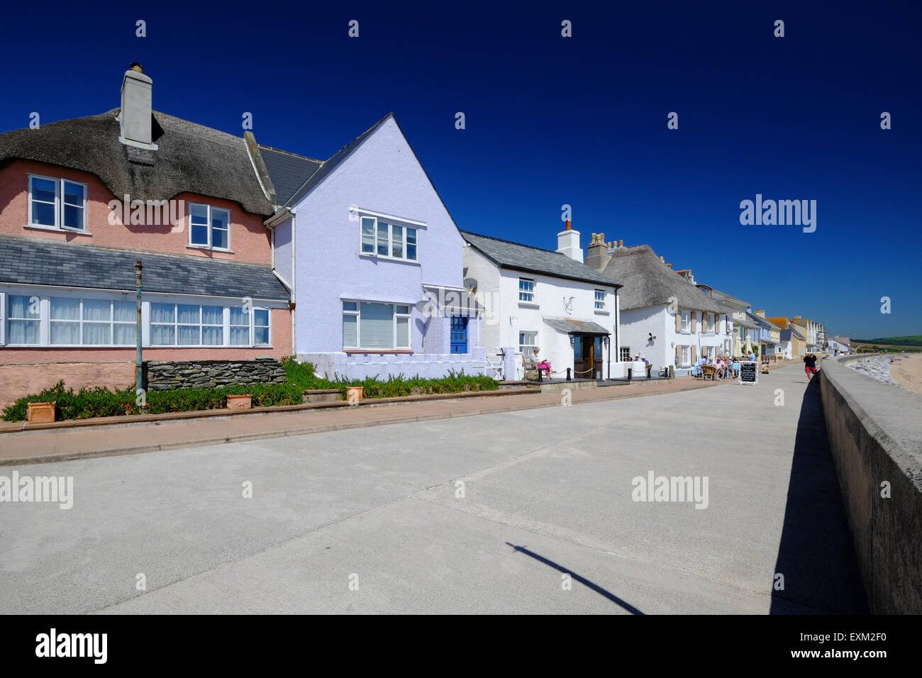 Torcross, Devon, UK.  Pastel coloured thatched cottages and houses face the beach at Torcross in Devon. Stock Photo