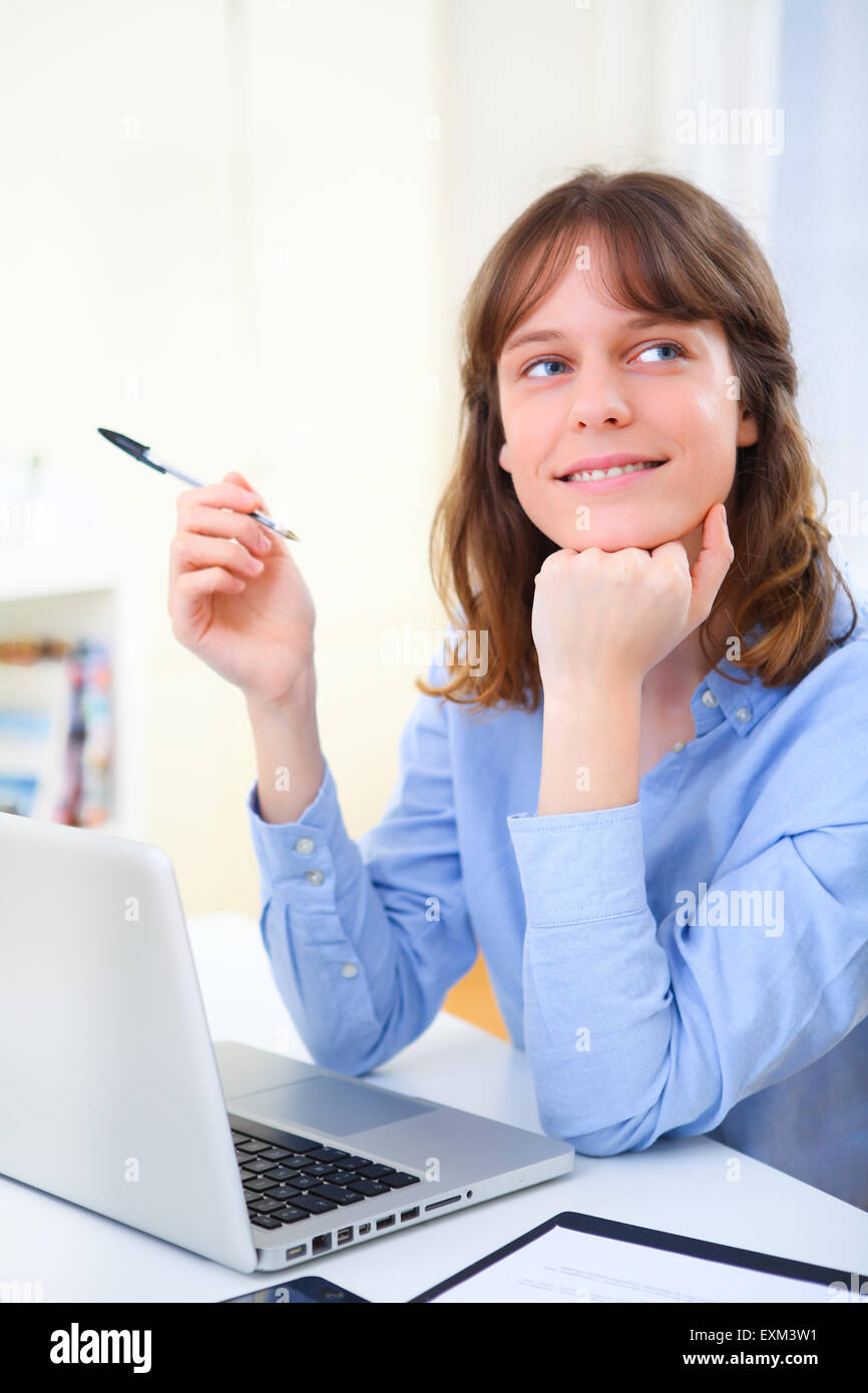 View of a young smiling business woman at work Stock Photo - Alamy
