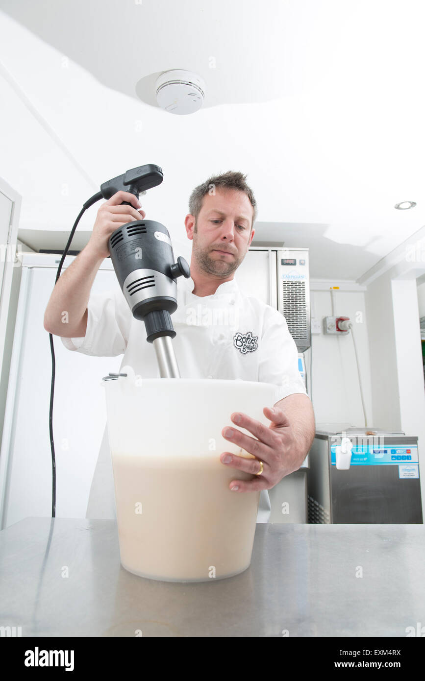 making ice cream in a professional kitchen, mixing it, adding the