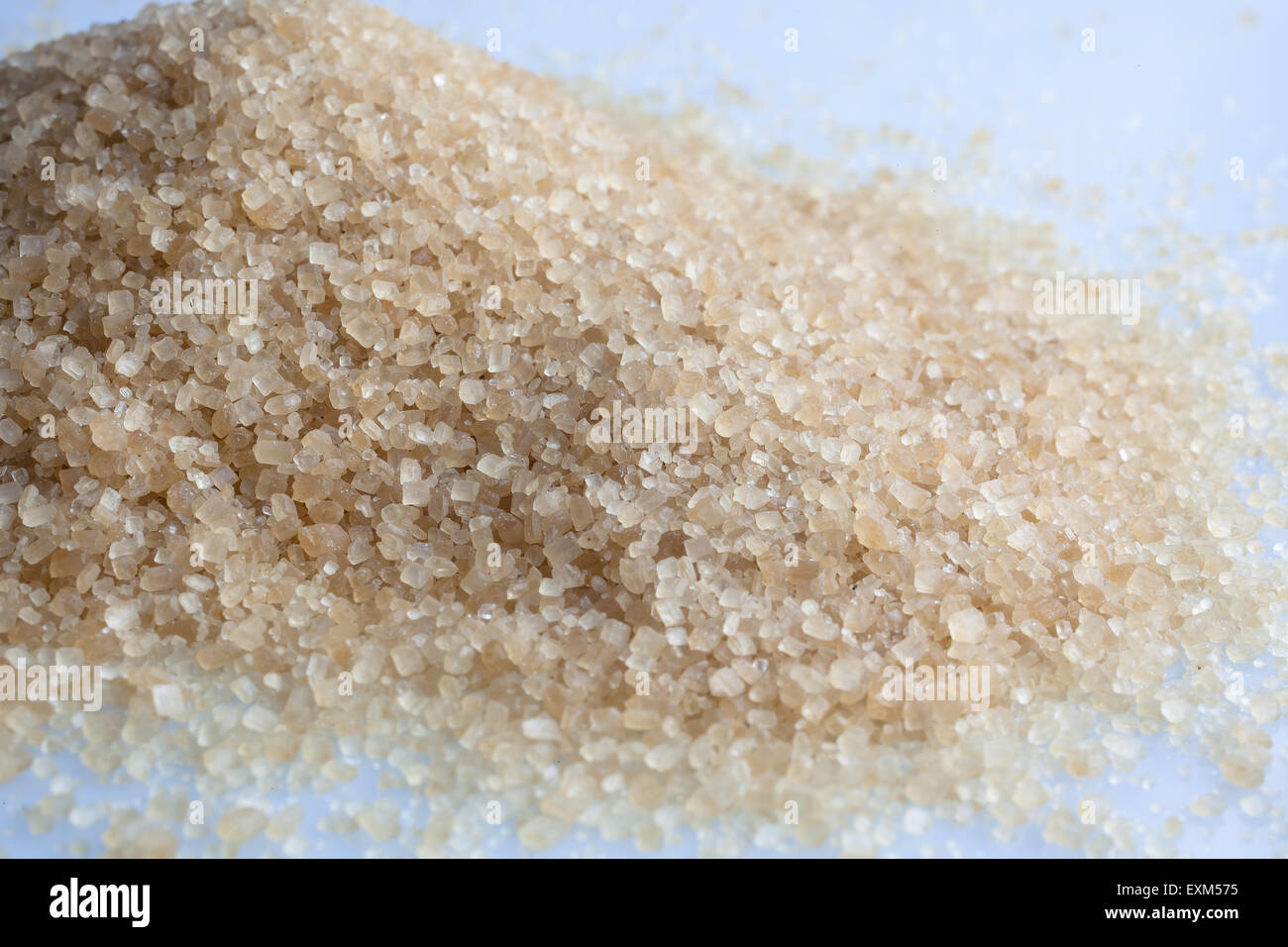 Brown sugar grains scattered on white background Stock Photo Alamy