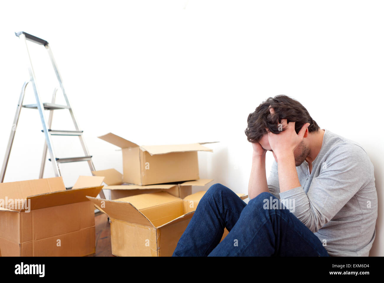 View of a Young man depressed while his moving out his flat Stock Photo