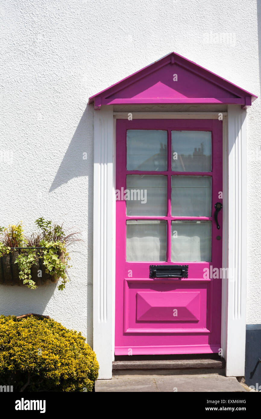 Pink half glazed front door to riverside terraced cottage at Emsworth, Hampshire, UK in July Stock Photo