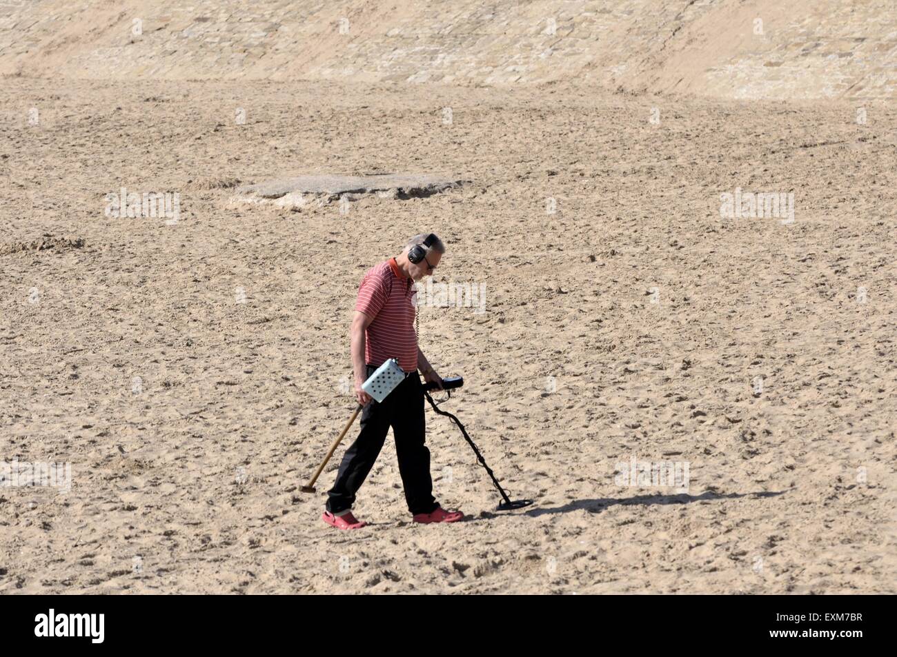 with metal detector on sandy beach Stock Photo Alamy