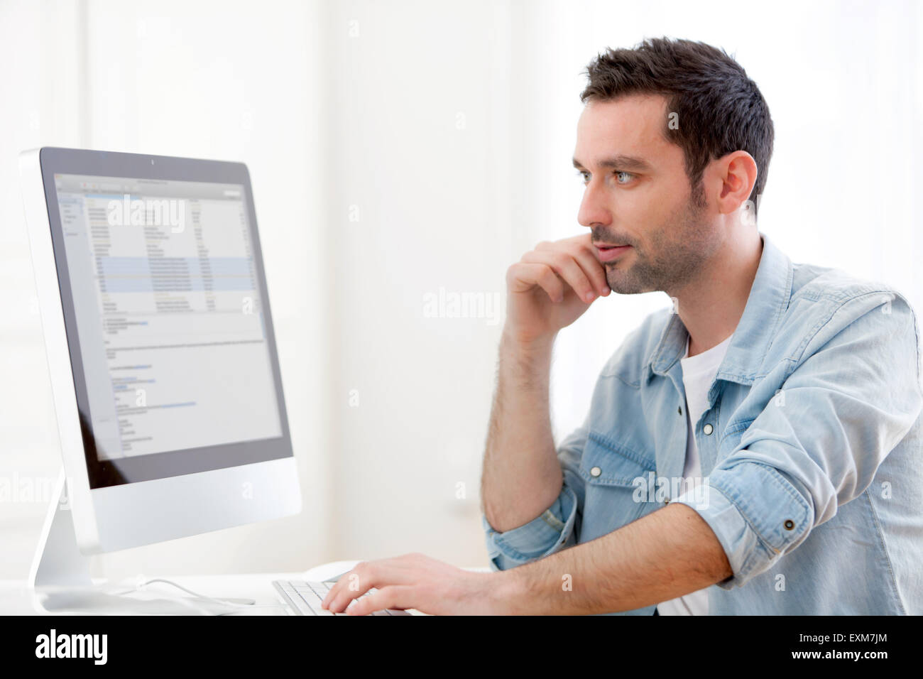 View of a young relaxed man using computer Stock Photo - Alamy