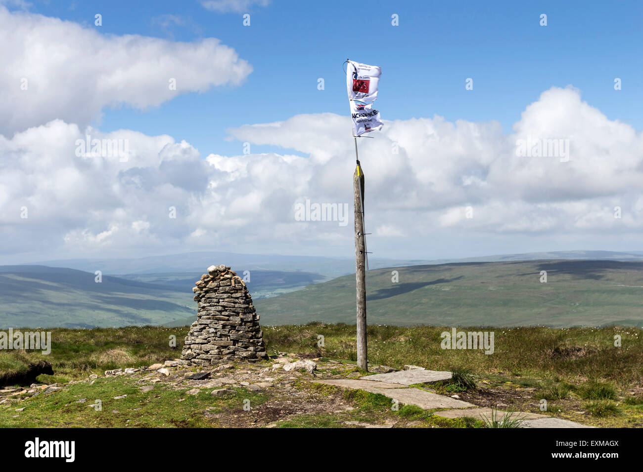 Cairn and 3 Peaks Challenge Flag on the Summit of Buckden Pike, Upper Wharfedale. Yorkshire Dales UK Stock Photo