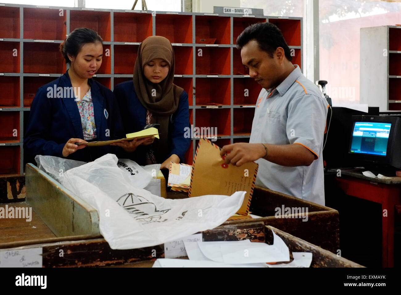 postal workers sorting mail at the main post office in malang java indonesia Stock Photo