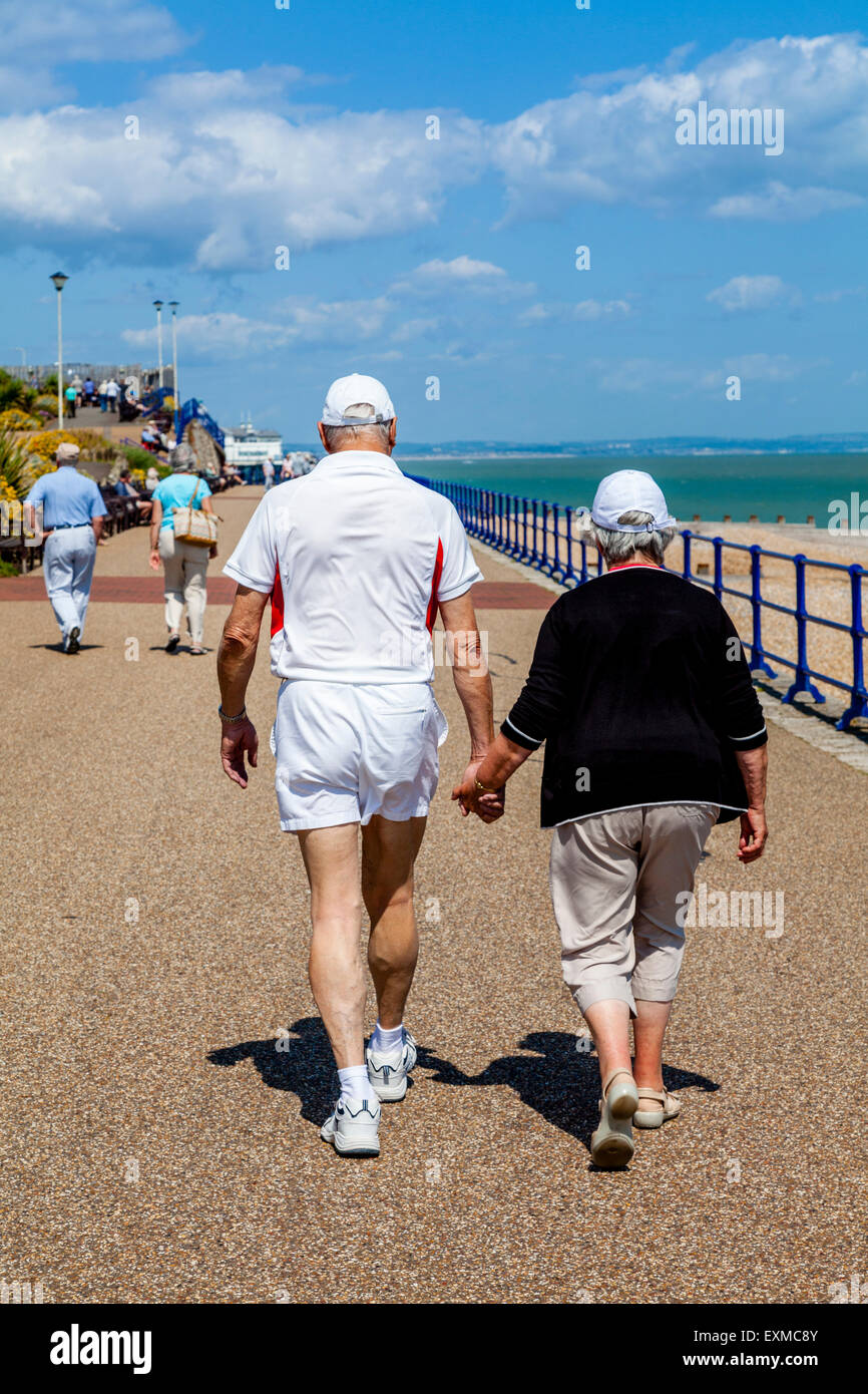 An Elderly Couple Walking Along The Seafront, Eastbourne, Sussex, UK Stock Photo