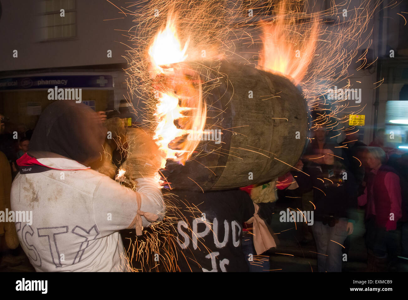 Intermediate burning barrel being carried through the street to mark