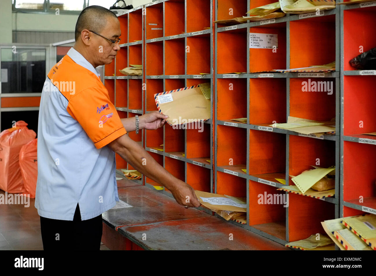 postal worker sorting mail at the main post office in malang java indonesia Stock Photo