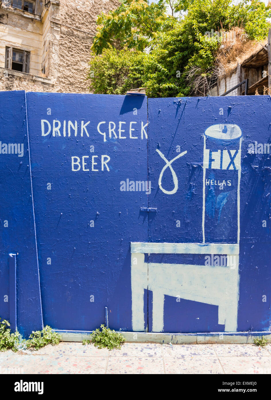 Graffiti on the blue fence that surrounds the ruin of Tom's Place in central Athens, Greece Stock Photo